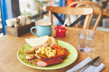 Brunch in restaurant with scramble eggs and coffee