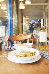 Dinner in restaurant with spaghetti pasta and wine