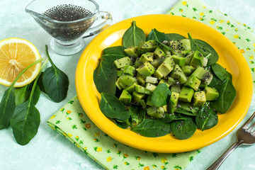 Vitamin vegetarian salad with avocado, kiwi, spinach and chia seeds