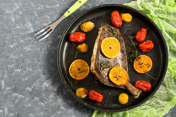 Flounder baked with mandarins and cherry tomatoes