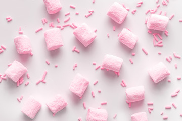 Obraz na płótnie Canvas flat lay of beautiful marshmallows and sprinkles, soft pink background