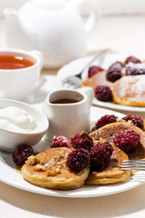 sweet corn pancakes with berries for breakfast, vertical