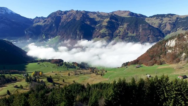Aerial view in the valley of Engelberg in the foothills of Switzerland on an autumn day with a sea of fog
