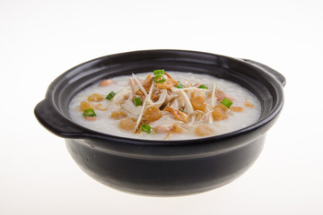Traditional chinese scallop porridge rice gruel served in claypot