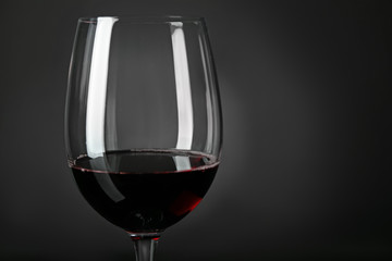 Glass of red wine on dark background, closeup