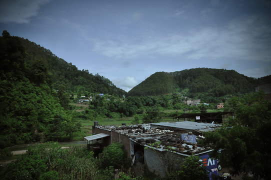 Fields, forests, mountains and blue sky.Side-by-side The countryside of Nepal is an ancient house that is still preserved. Old culture