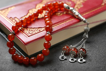 Holy book of Muslims and prayer beads, closeup