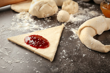 Dough with jam on table. Preparing tasty croissants