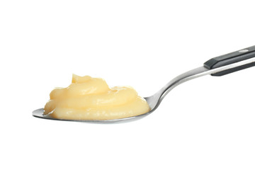 Tasty vanilla pudding in spoon on white background