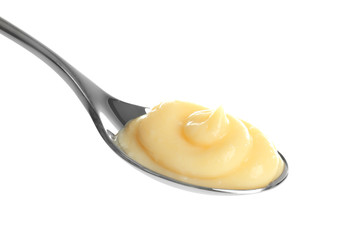 Tasty vanilla pudding in spoon on white background - obrazy, fototapety, plakaty