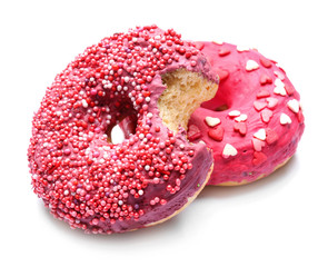 Delicious glazed doughnuts with sprinkles on white background