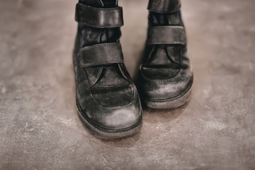 Old shoes on grey background. Poverty concept