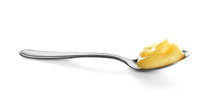 Tasty vanilla pudding in spoon on white background
