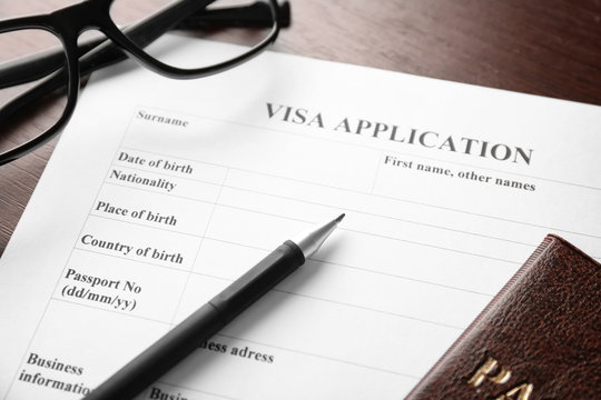 Visa application form on table. Immigration and citizenship