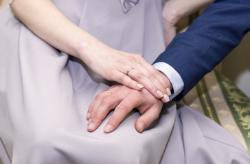 hands of the newlyweds, wedding rings on the hands of the newlyweds, the bride and groom