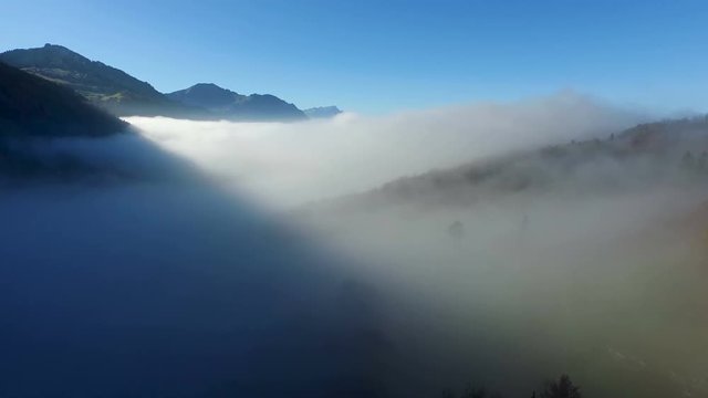 Aerial view in the valley of Engelberg in the foothills of Switzerland on an autumn day with a sea of fog