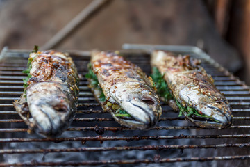 Roasted carcass fish mackerel cooked on the grill, top view, close-up