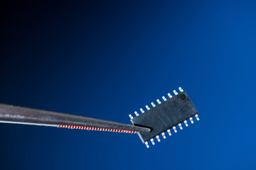 Electronic chip isolated on dark blue