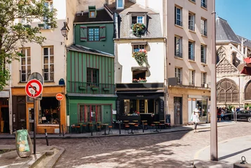 Fototapeten Typical view of the Parisian street with tables of cafe in Paris, France. © Ekaterina Belova