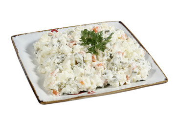 bowl of traditional russian salad on white background