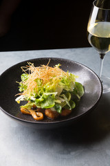 Squid salad served on a black plate