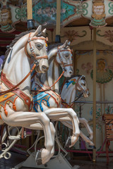 Fototapeta na wymiar Colorful Carousel Horses in a Holiday Park, Merry-go-round Horse