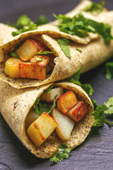 Vegetarian masala dosa with potato, chutney and sambar sauces.