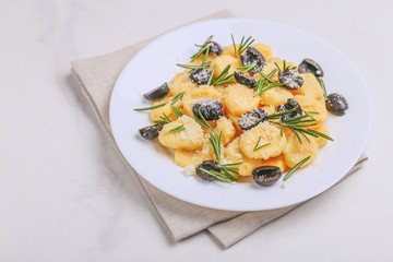 Italian Gnocchi with cream sauce, olives and rosemary