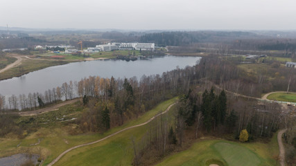 autumn golf field on lake shore Lithuania Aerial drone top view