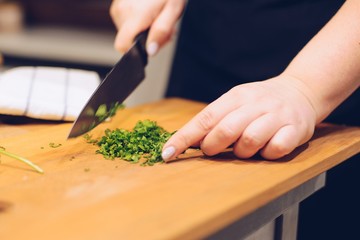 Woman cutting green coriander herb