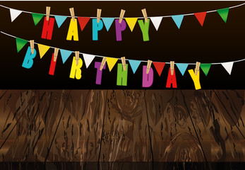 The letters of Happy Birthday hang on clothespins on a rope.