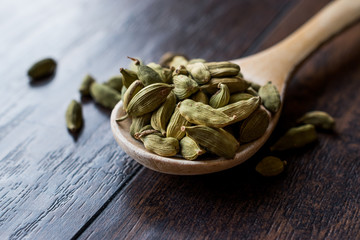 Cardamom Seeds in Wooden Spoon.