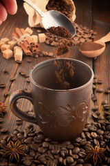 clay cup with coffee on the background of grains