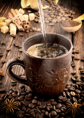 clay cup with coffee on the background of grains