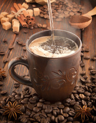clay cup with coffee on the background of grains