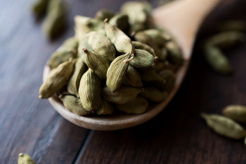 Cardamom Seeds in Wooden Spoon.