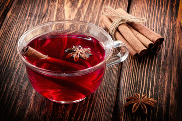 glass cup with mulled wine on a wooden table