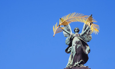 Statue of glory. Facade of the Opera and Ballet Theater. Bronze, Gold (ars longa vita brevis)