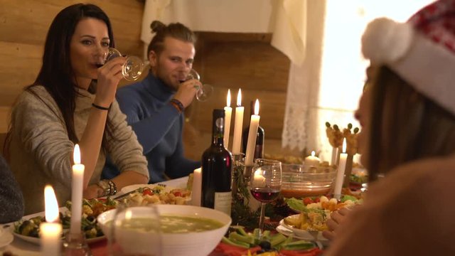 People drinking wine at the Christmas dinner