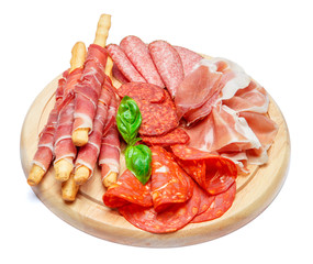 Cold smoked meat plate with pork chops, prosciutto, salami and bread sticks