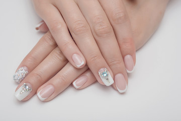 Light manicure in light on a white background.