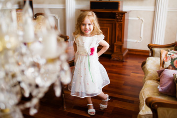 A little blond girl in colorful dress