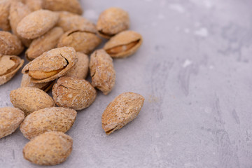 Close-up heap almonds nuts with copy space