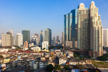 Fototapeta premium Contrast between new and holding buildings in Bangkok, Thailand skyline