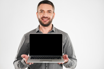 Businessman showing display of laptop computer.