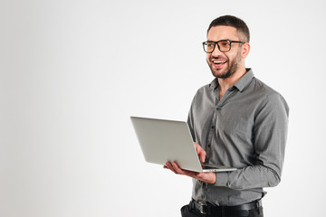 Laughing businessman using laptop computer.
