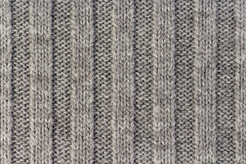 Knitting. Vertical striped gray knit fabric texture, knitted pattern background
