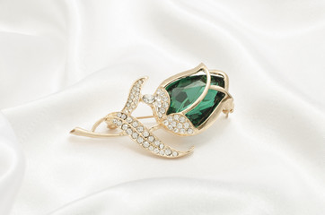 gold brooch rose bud with emerald and diamonds on silk