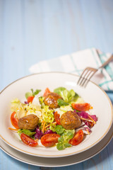 Colorful fresh vegetable salad with meatballs