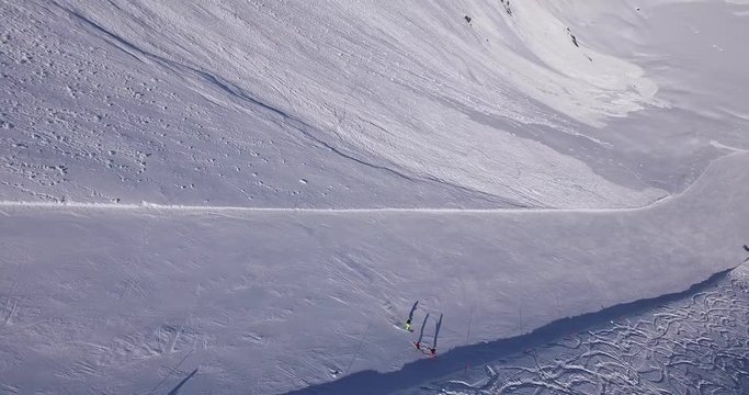 Birds eye view following a skier rushing down the piste in the Swiss Alps